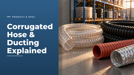 Coils of clear polyurethane ducting with copper wire helix, black corrugated PVC hose, red silicone air ducting and silver aluminium ducting on a steel inspection bench in a hose warehouse